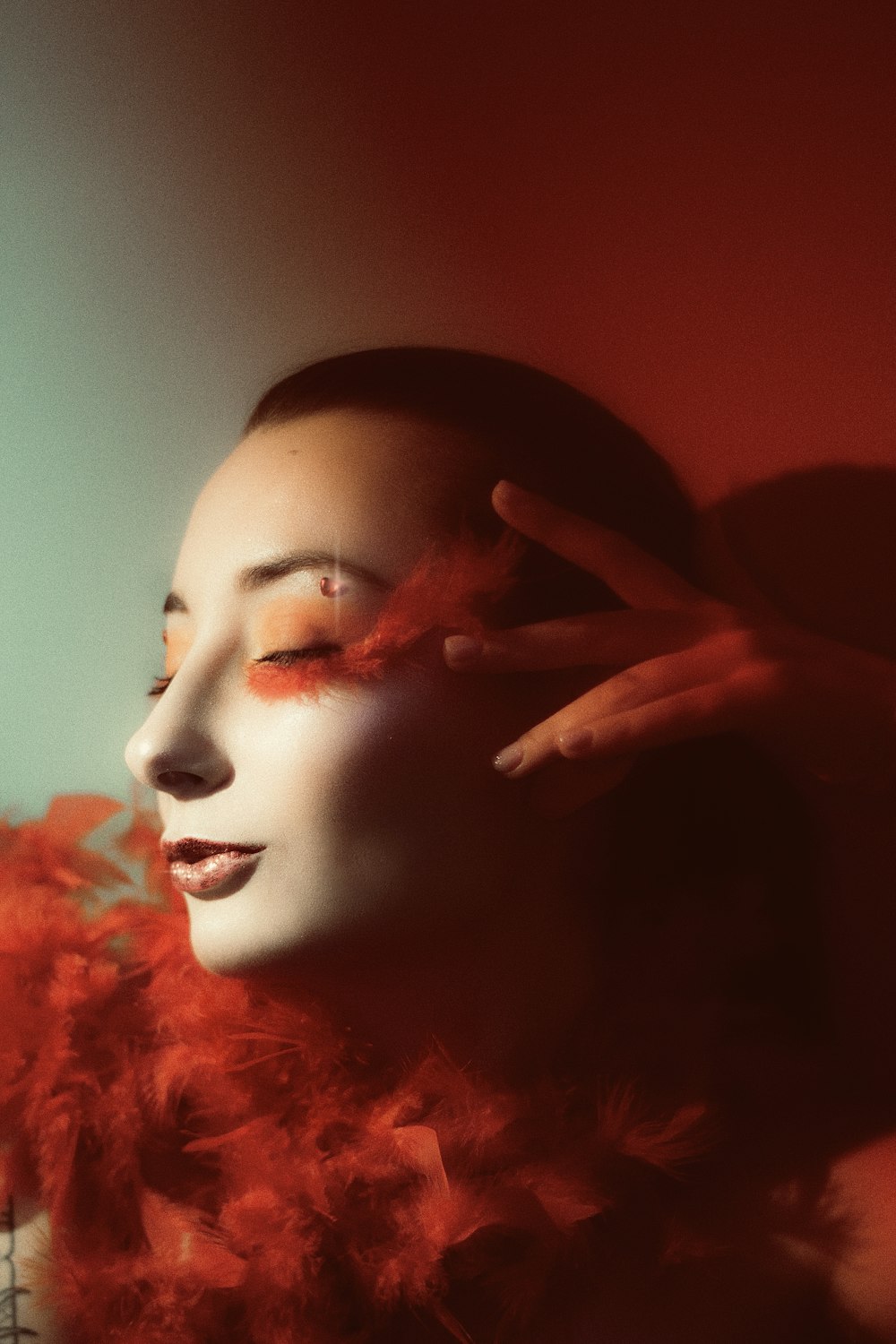 a woman with red feathers on her face