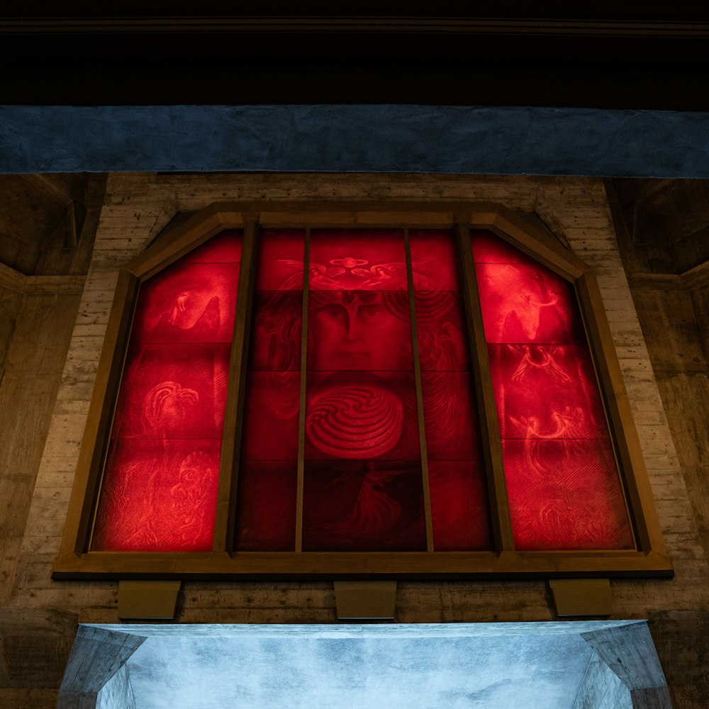 a window with a red light shining through it