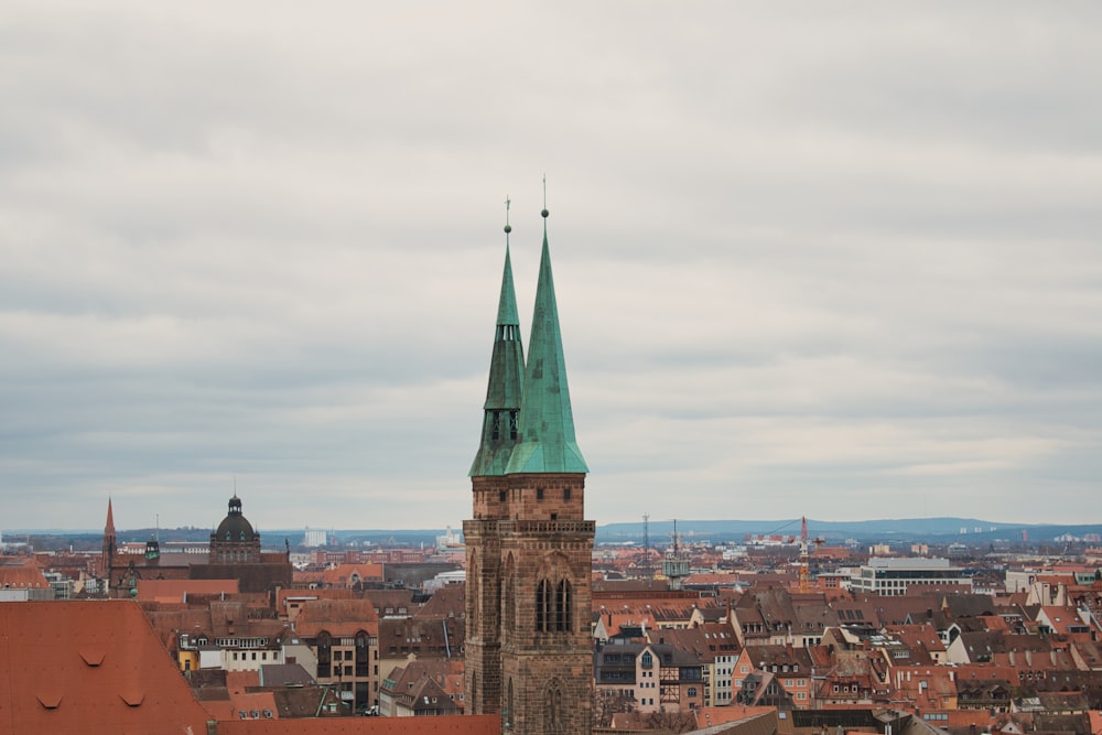 a tall building with a green steeple on top of it