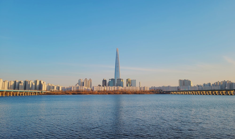 a large body of water with a city in the background