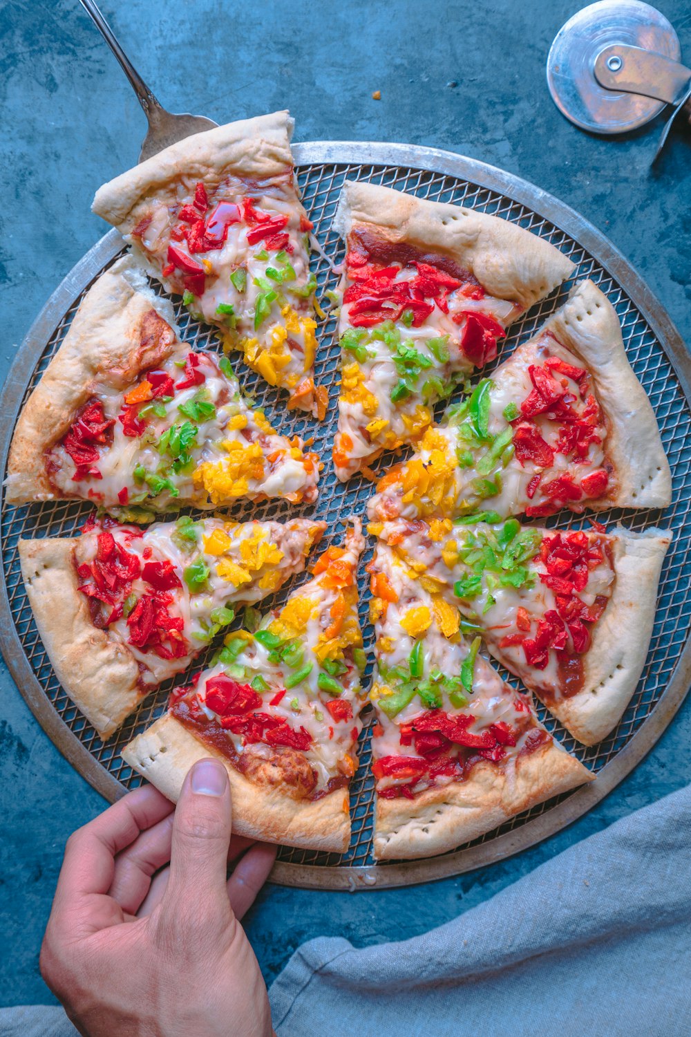 a person holding a pizza on a pizza pan