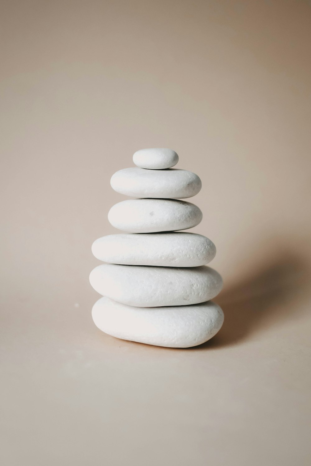 a stack of white rocks sitting on top of a table