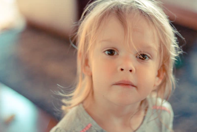 A candid shot of a child’s curious gaze, bathed in soft natural light.