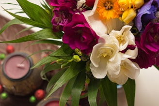 A vibrant bouquet of flowers in warm colors displayed at a wedding venue.