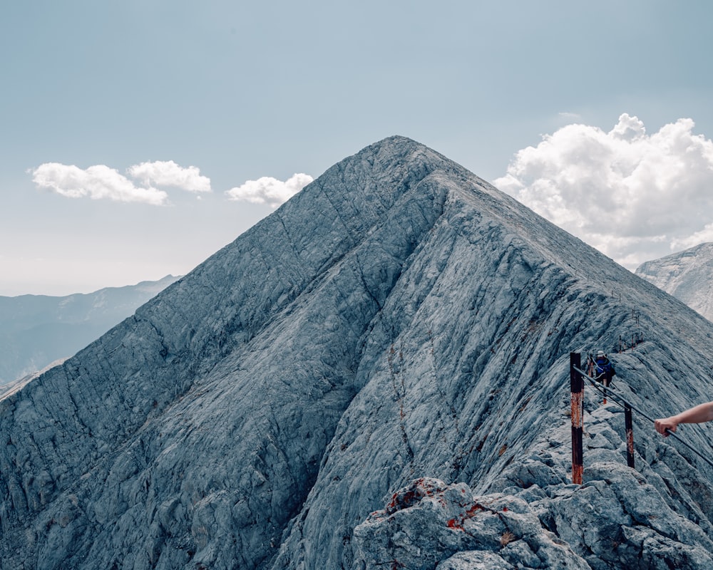 a person standing on top of a mountain with a camera