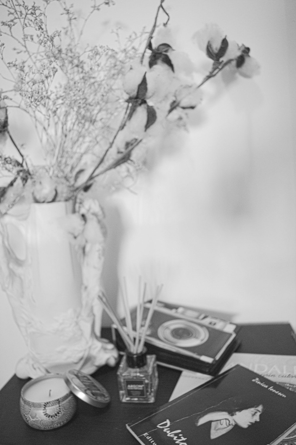 a vase filled with flowers sitting on top of a table