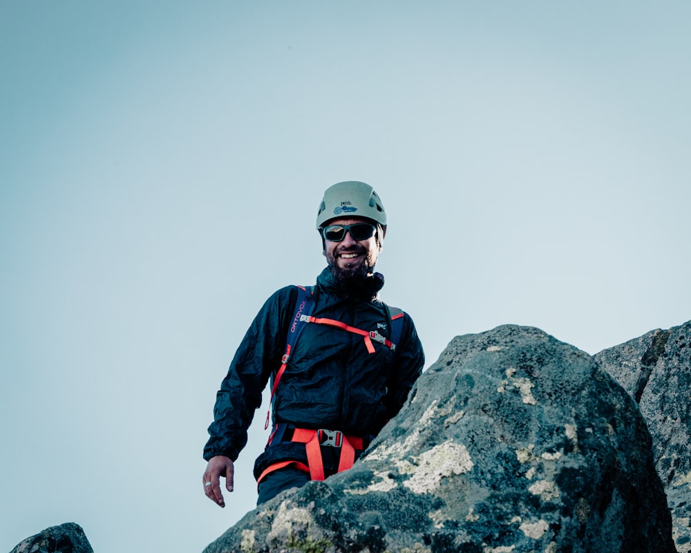 a man standing on top of a large rock