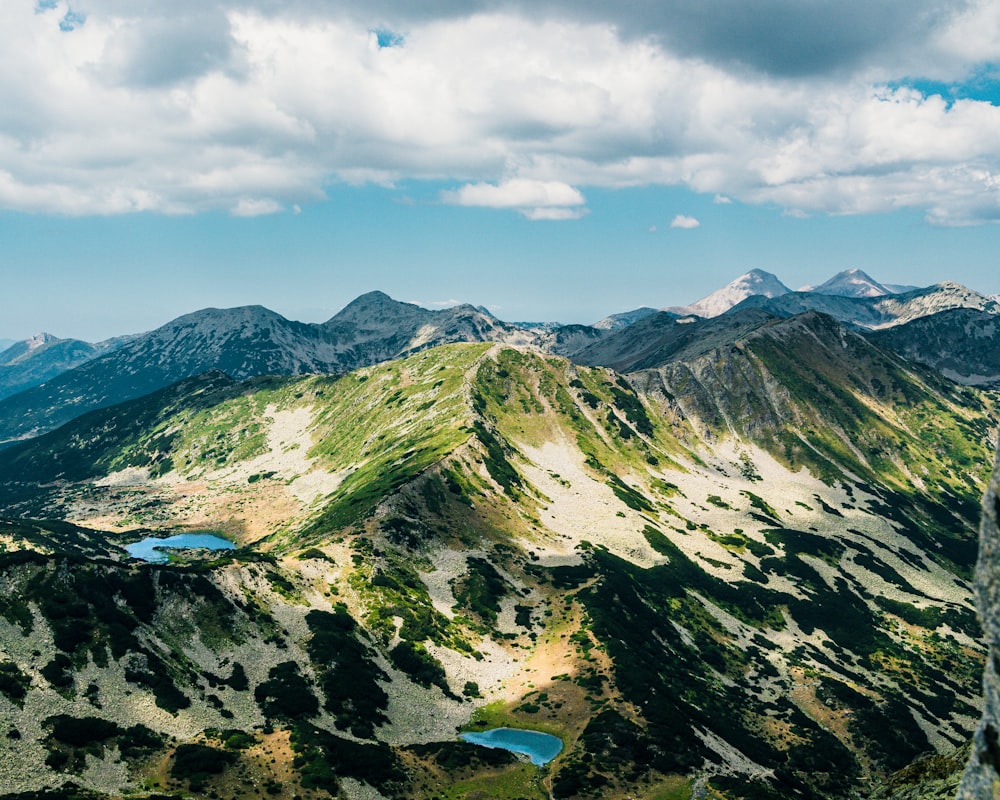 a view of a mountain range with a lake in the middle