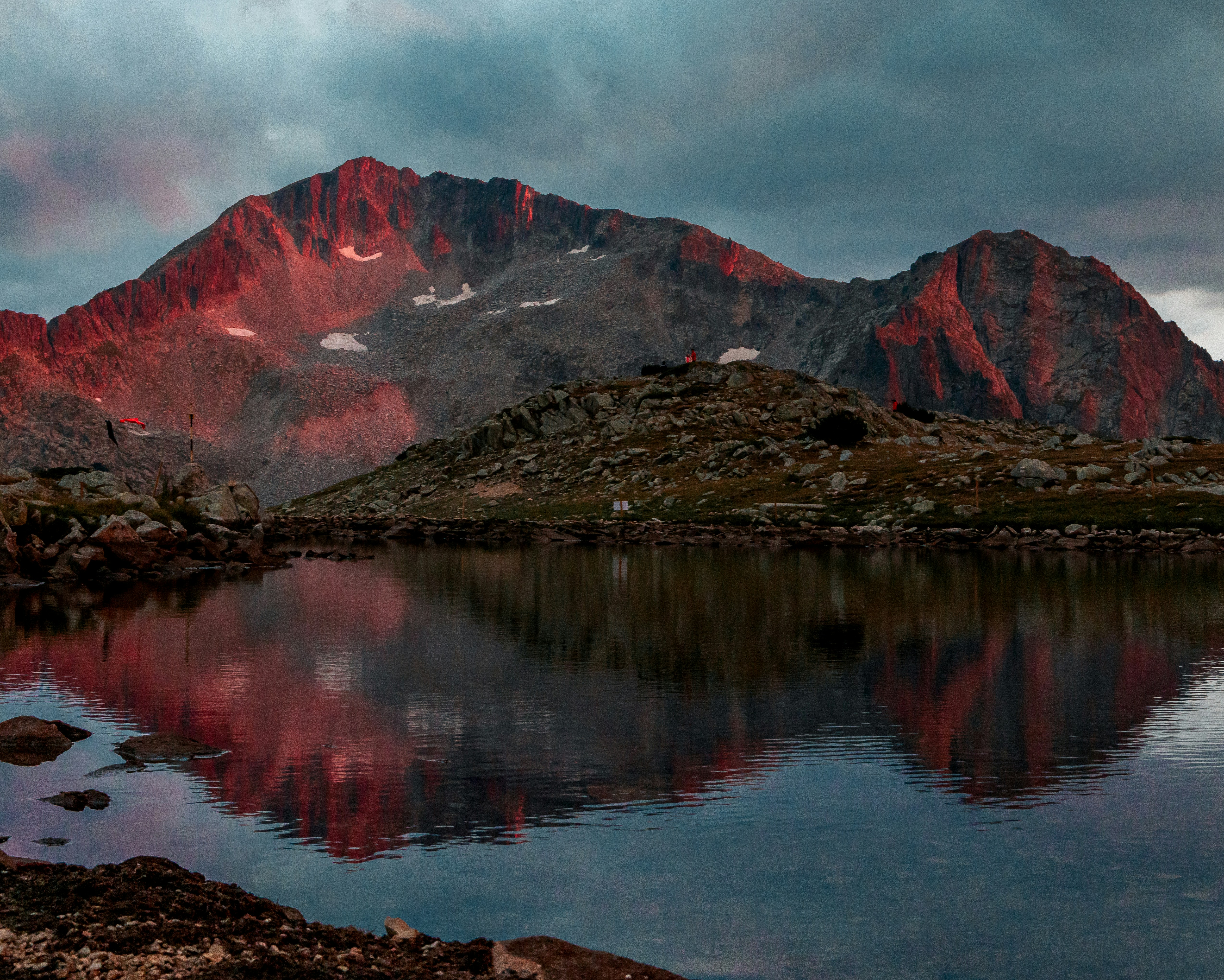 a mountain range with a lake in the foreground