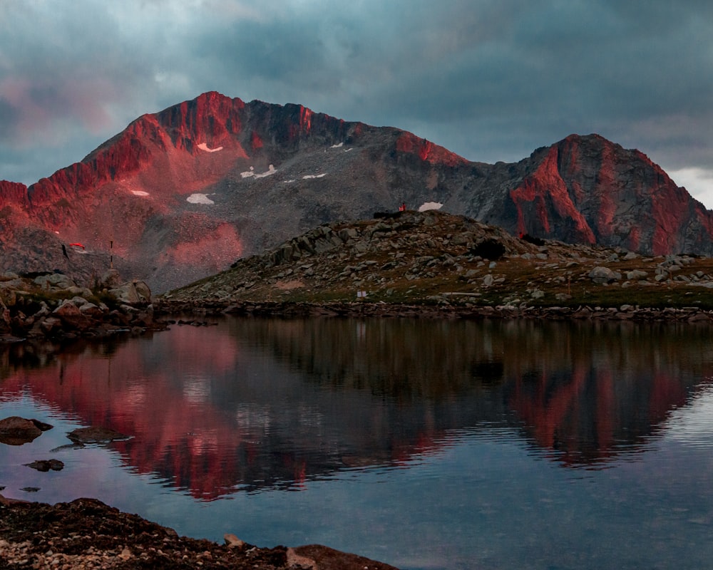 a mountain range with a lake in the foreground