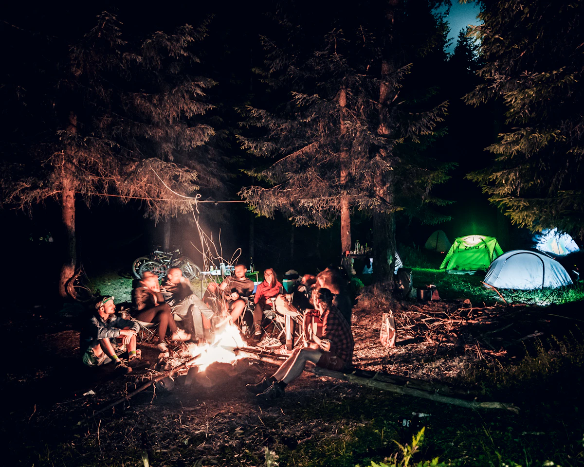 Night campfire among tents