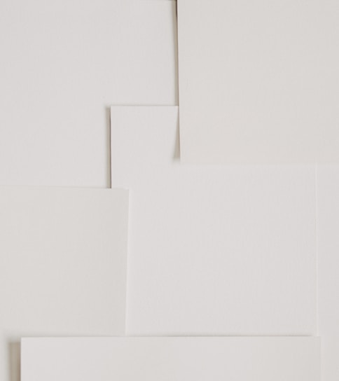 A clean and minimalistic image of various paper products arranged aesthetically.