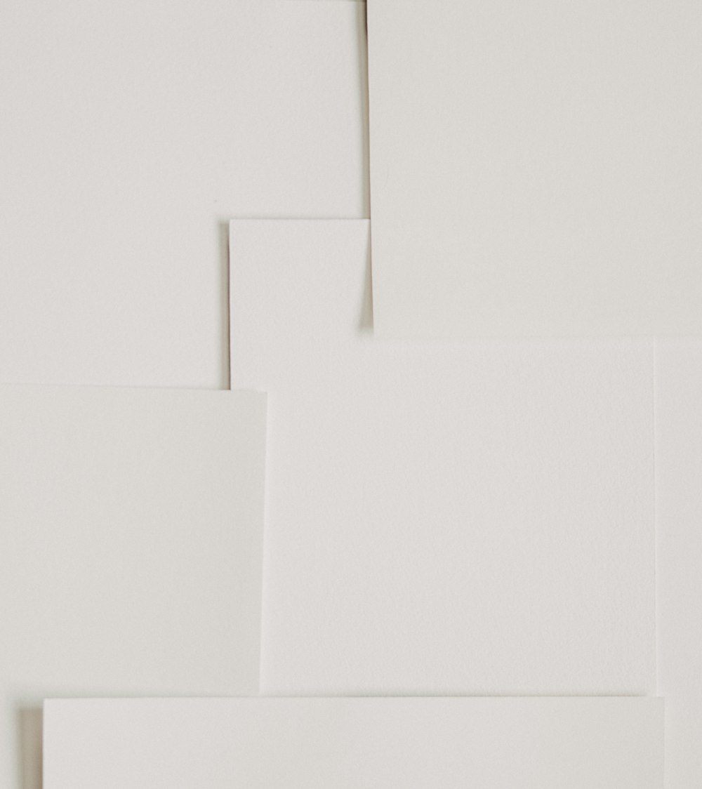 a white wall with several pieces of paper on top of it