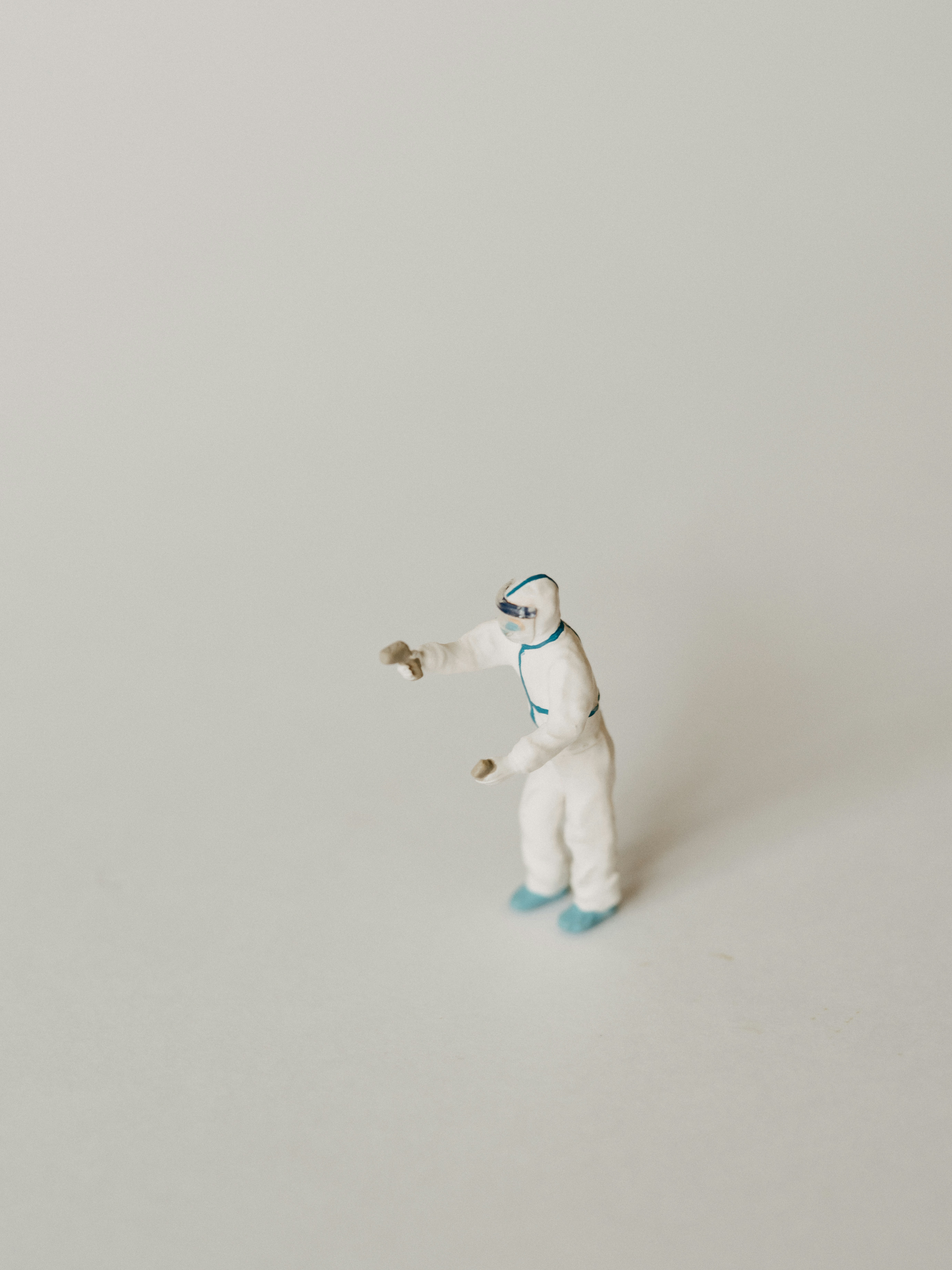 a small white polar bear figurine on a white surface