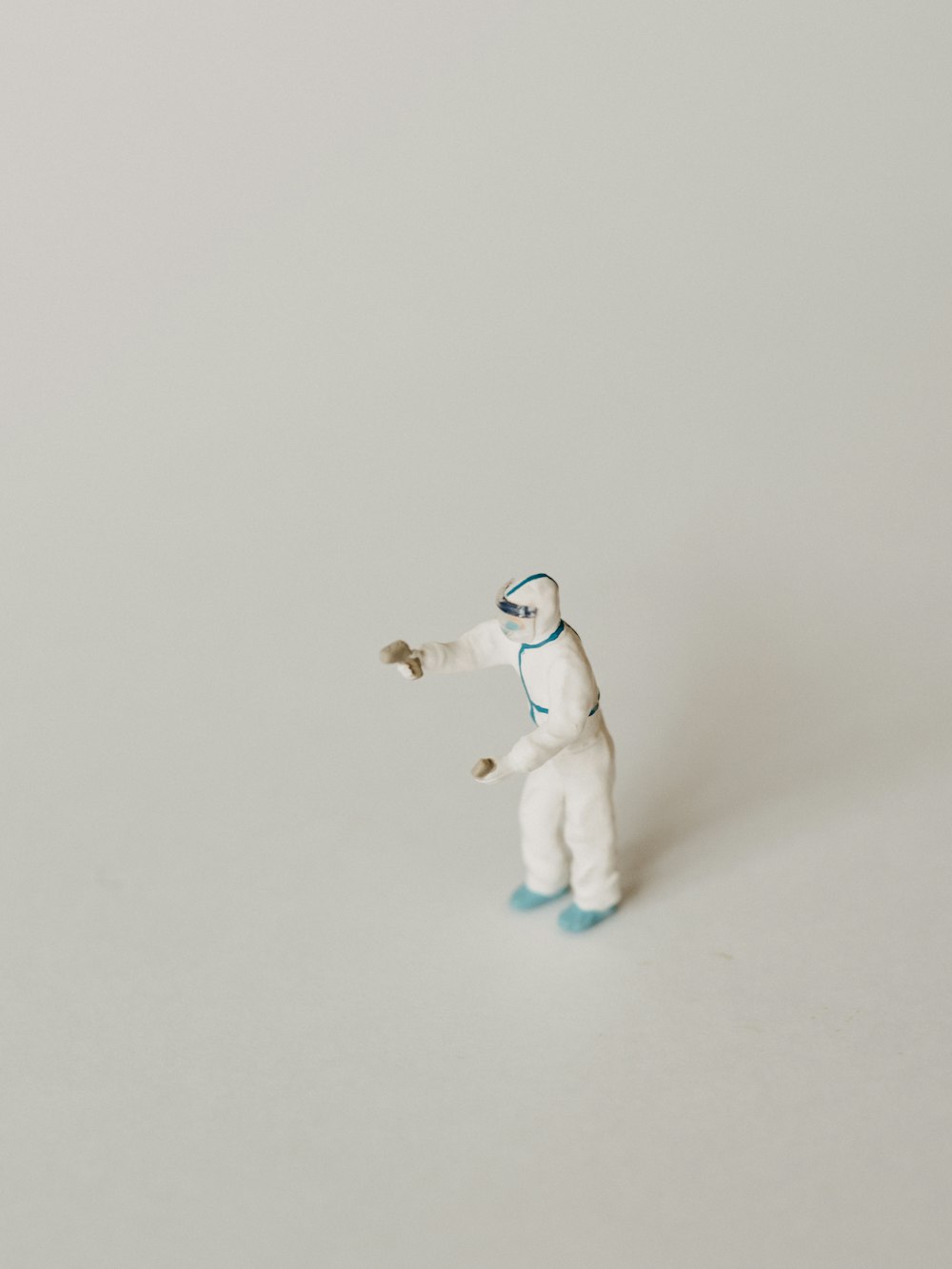 a small white polar bear figurine on a white surface