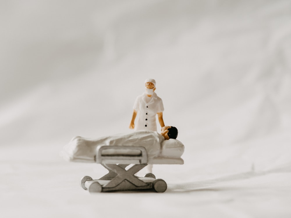 a toy of a person laying on a hospital bed