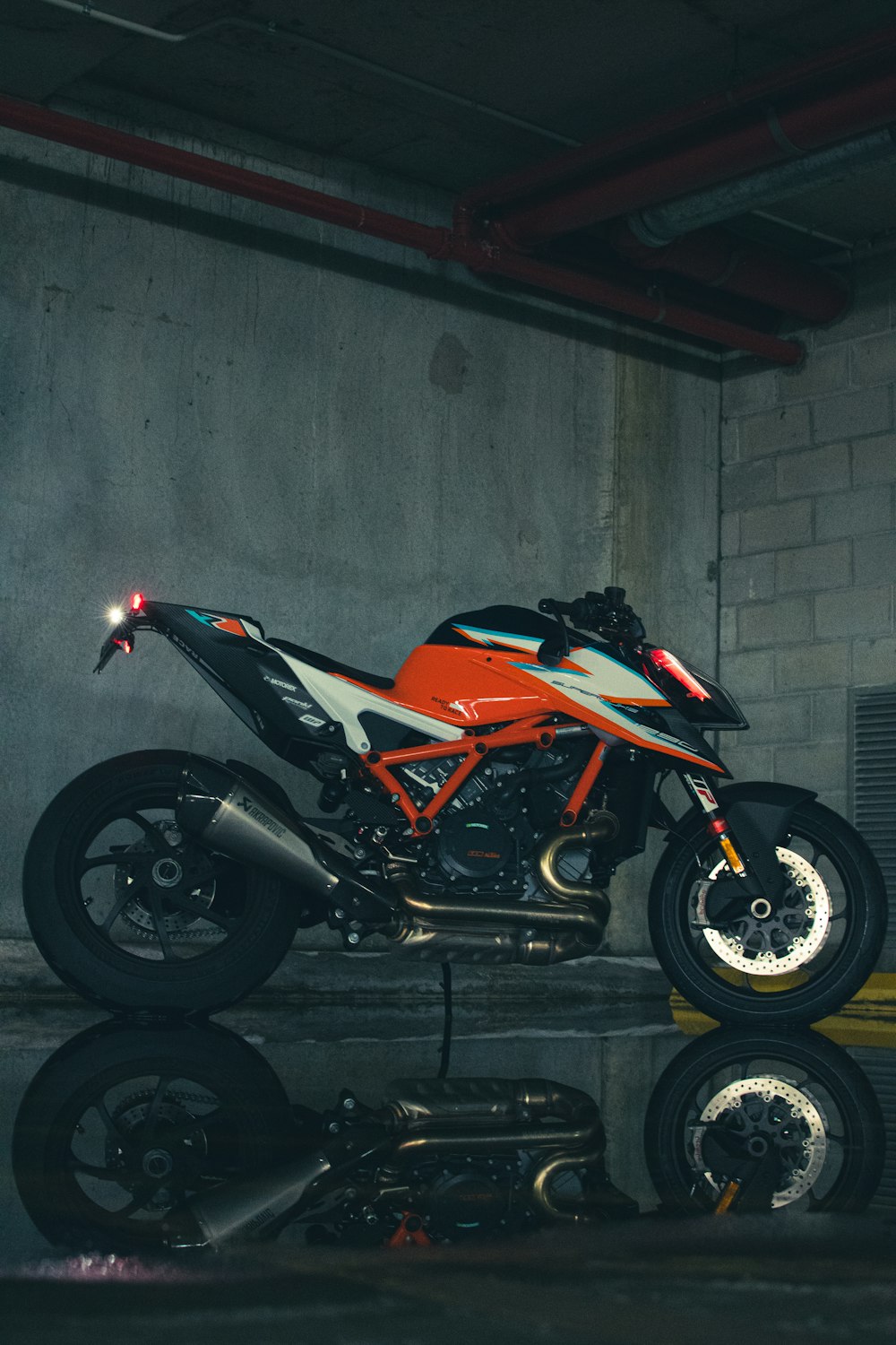 a motorcycle parked inside of a garage next to a wall