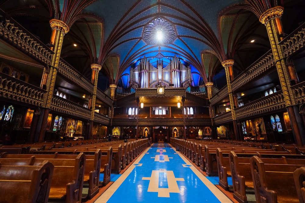 a church with a blue and white floor and pews