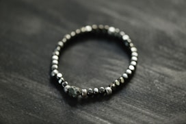 a beaded bracelet on a black surface