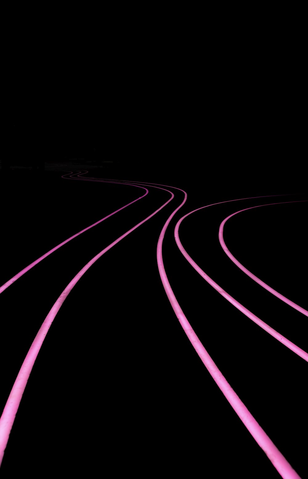 a black and pink photo of a train track