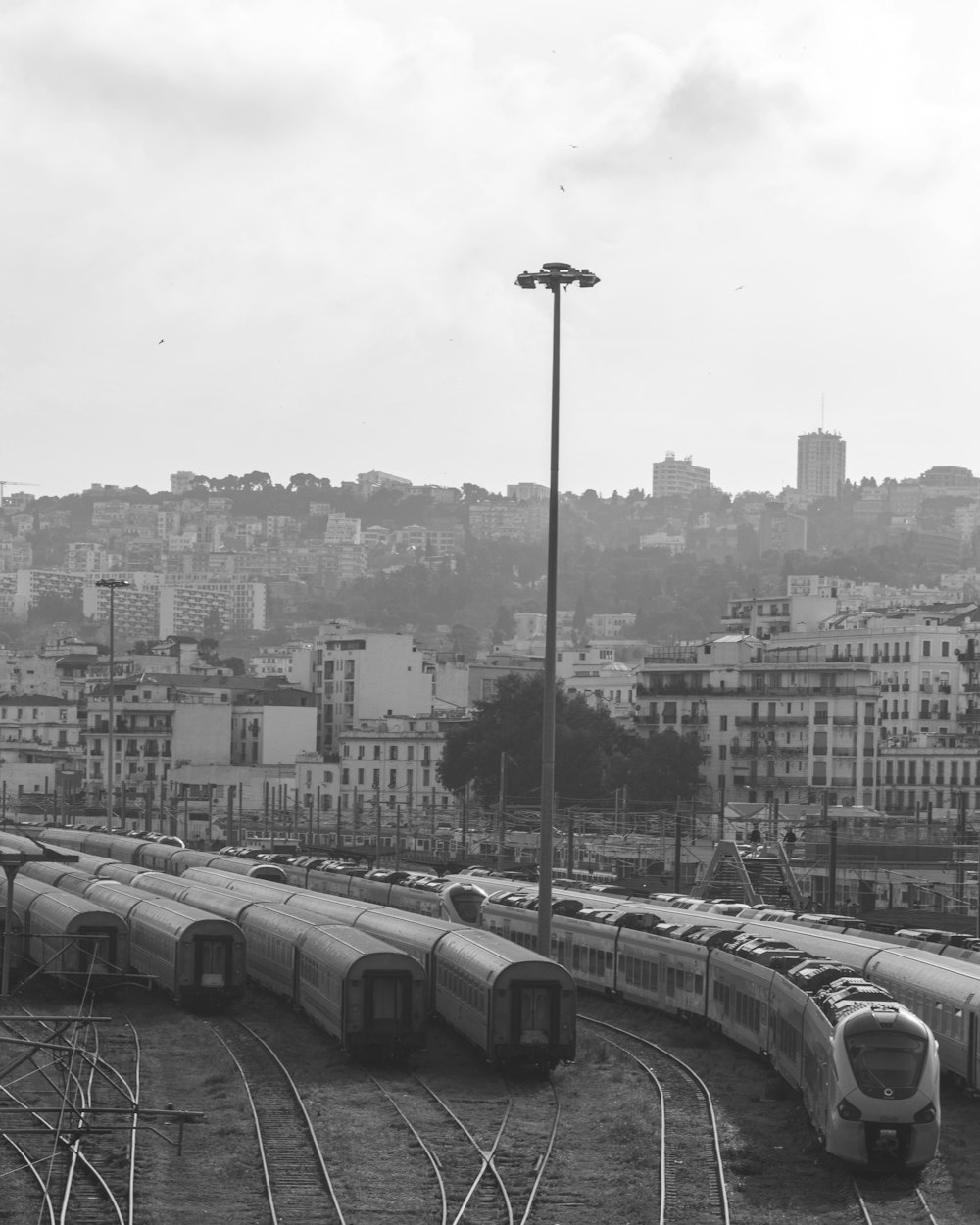 a black and white photo of a train yard