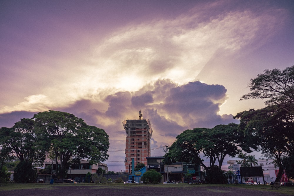 a tall building sitting under a cloudy sky