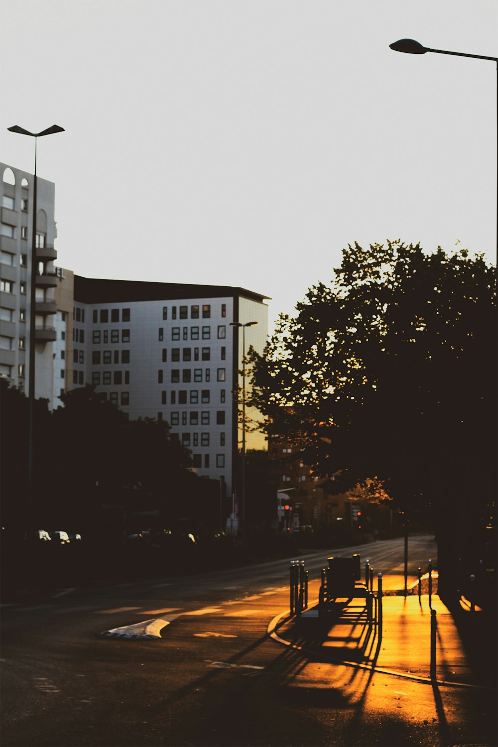 a city street with tall buildings in the background