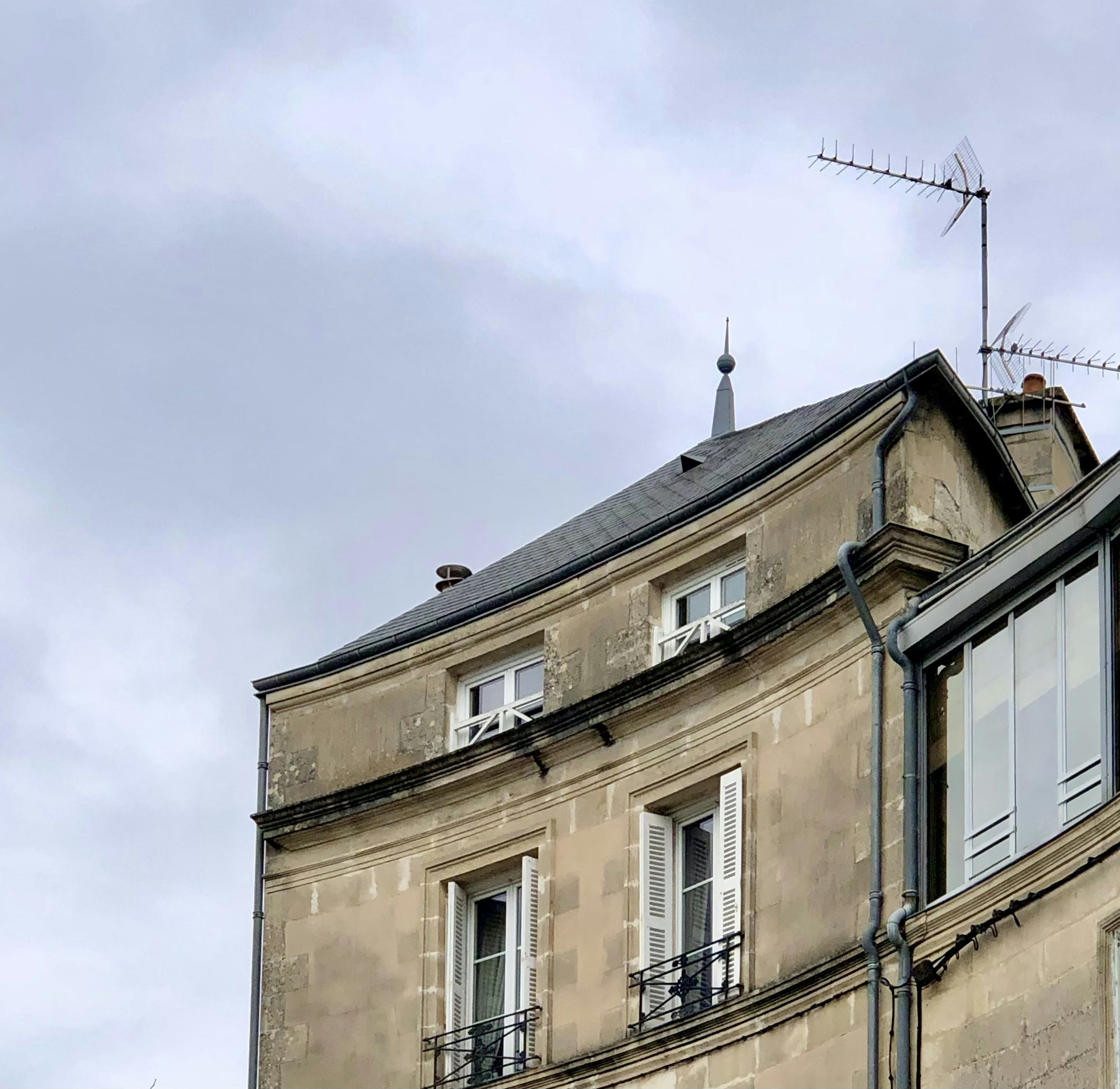 a tall building with a weather vane on top of it