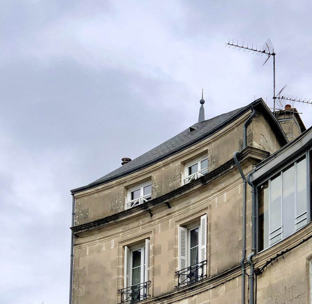 a tall building with a weather vane on top of it