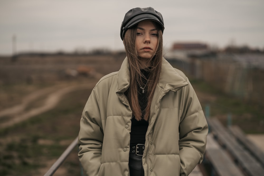 a woman standing in front of a train track