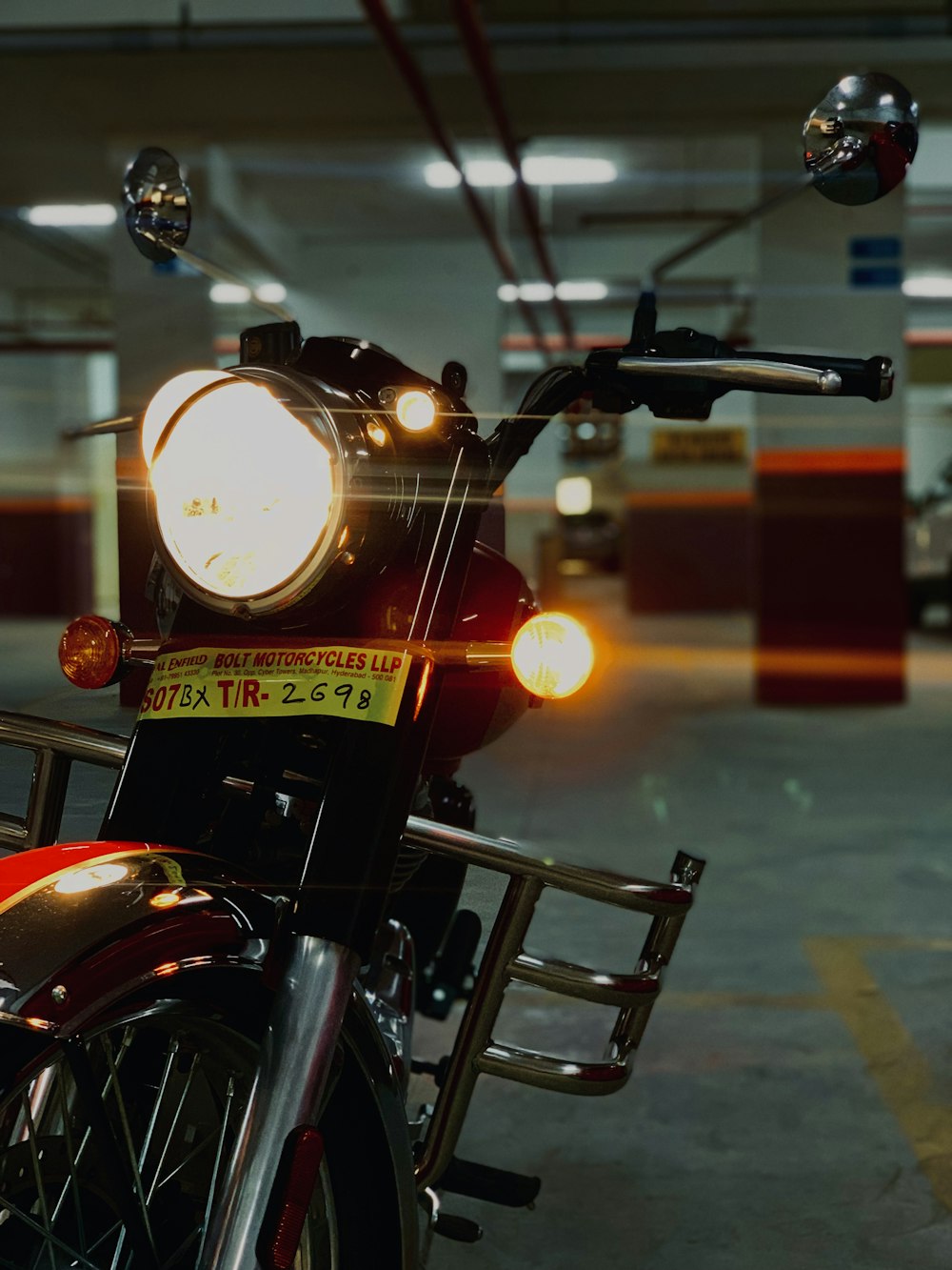 a red motorcycle parked in a parking garage
