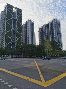 a city street with tall buildings in the background