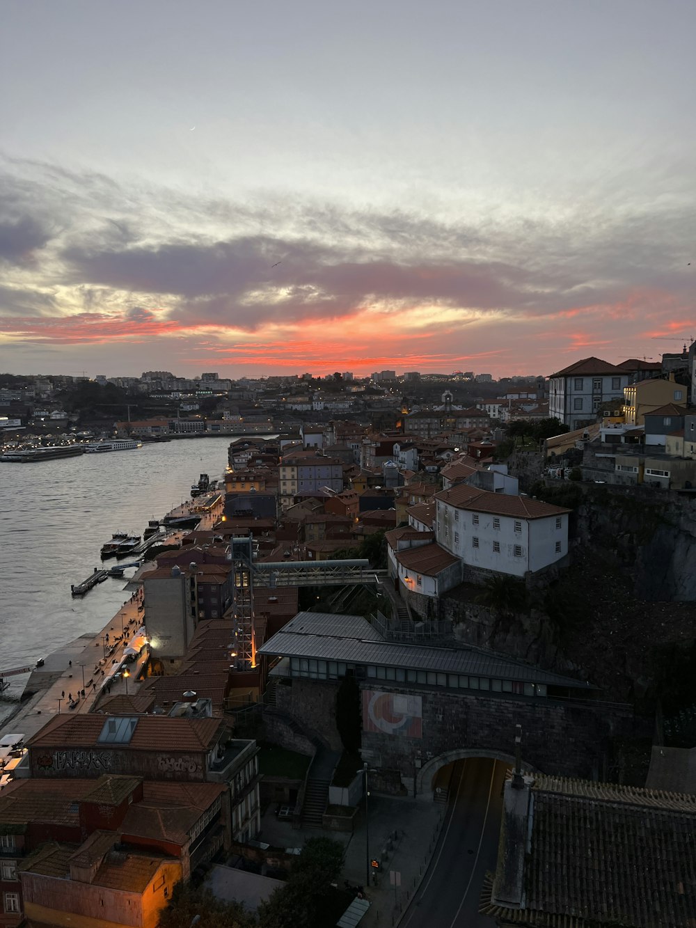 a view of a city and a river at sunset