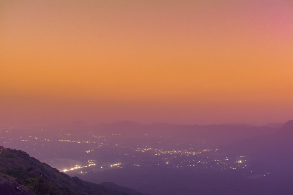 a view of a city at night from a hill