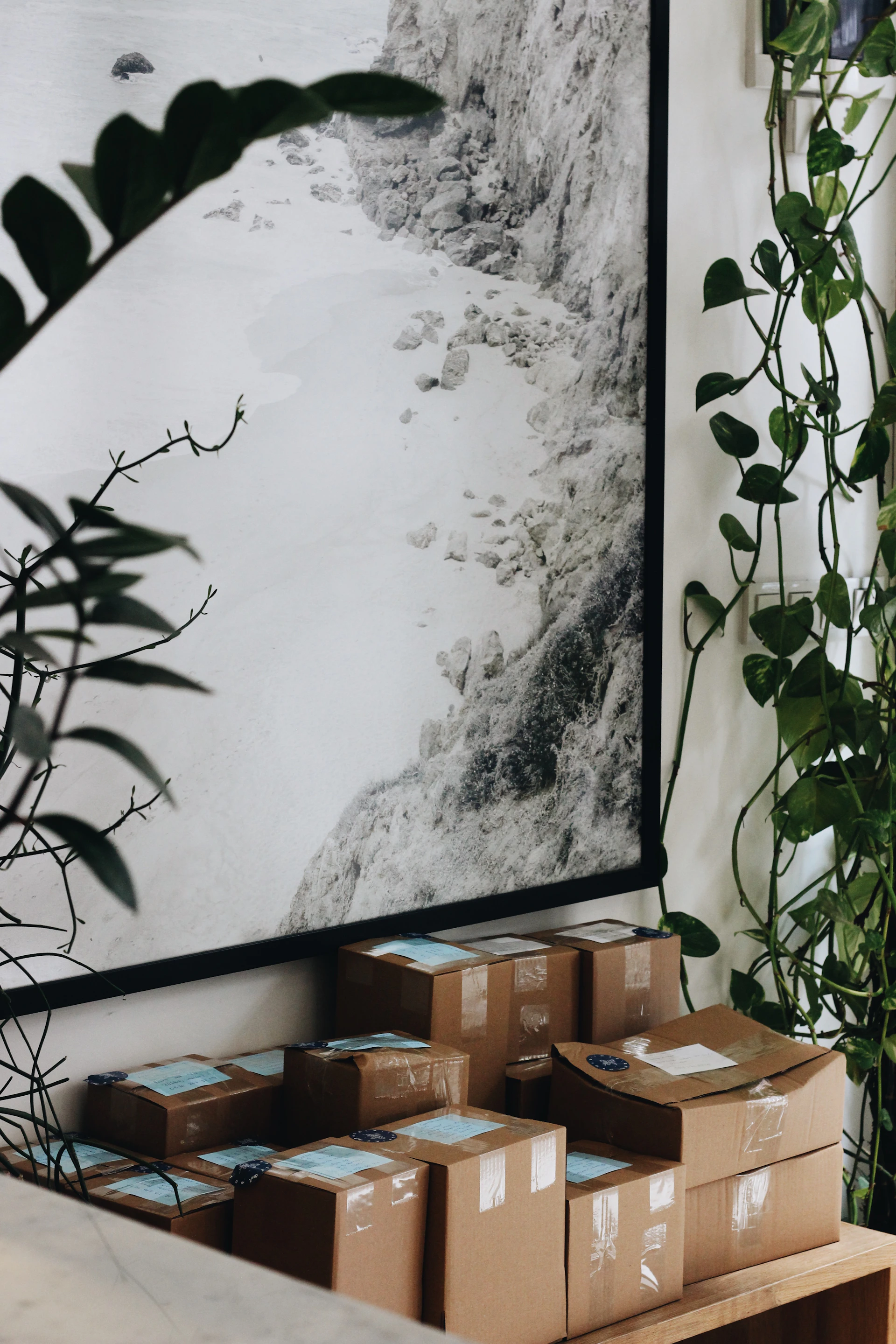 boxes are stacked on a table in front of a picture