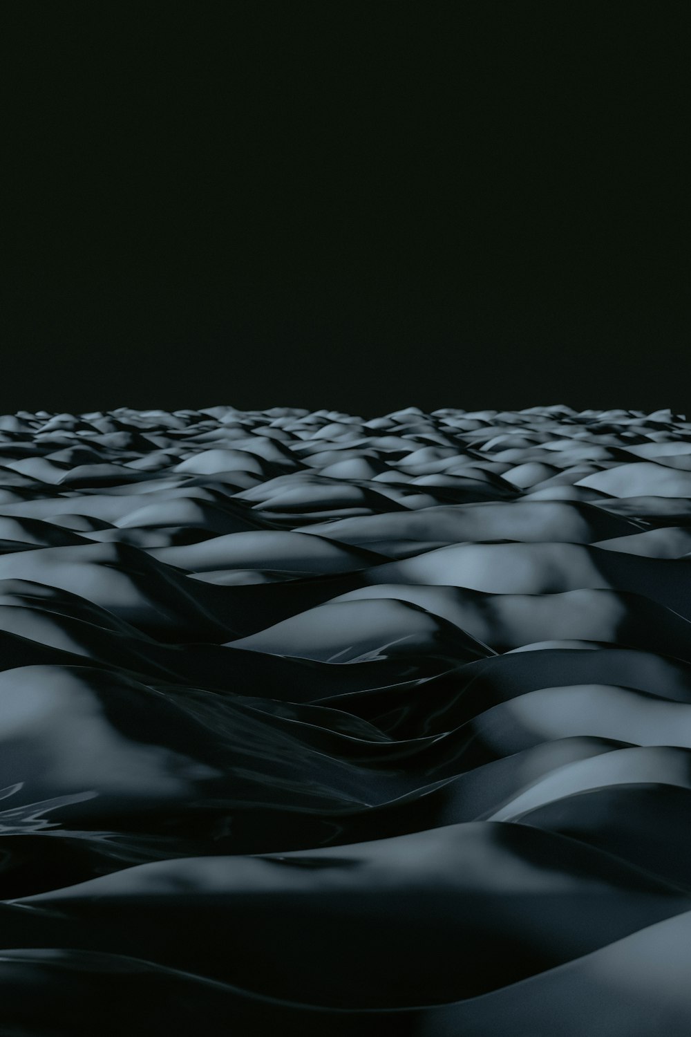 a black and white photo of a large amount of sand dunes