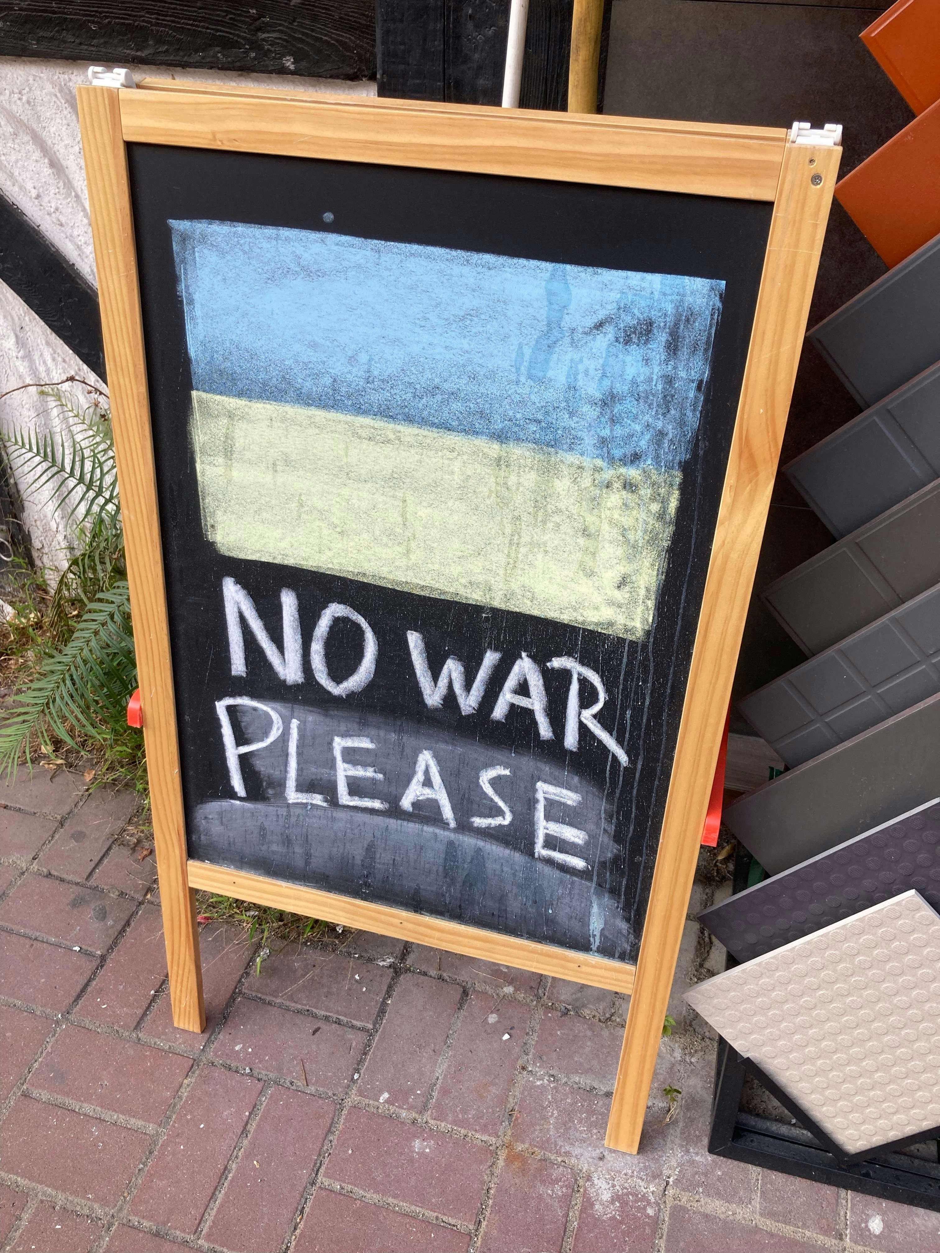 A message showed or no war please in a blackboard