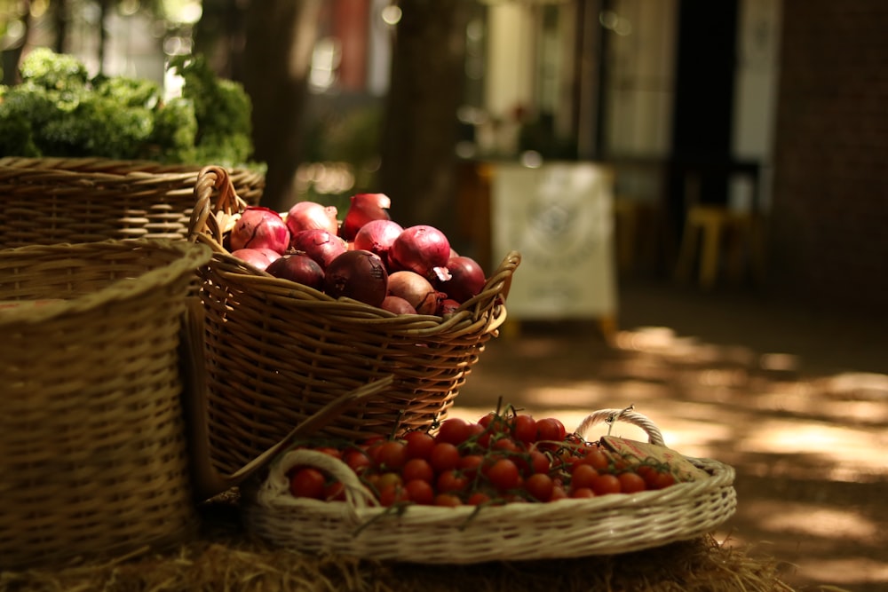 a basket of tomatoes and a basket of strawberries