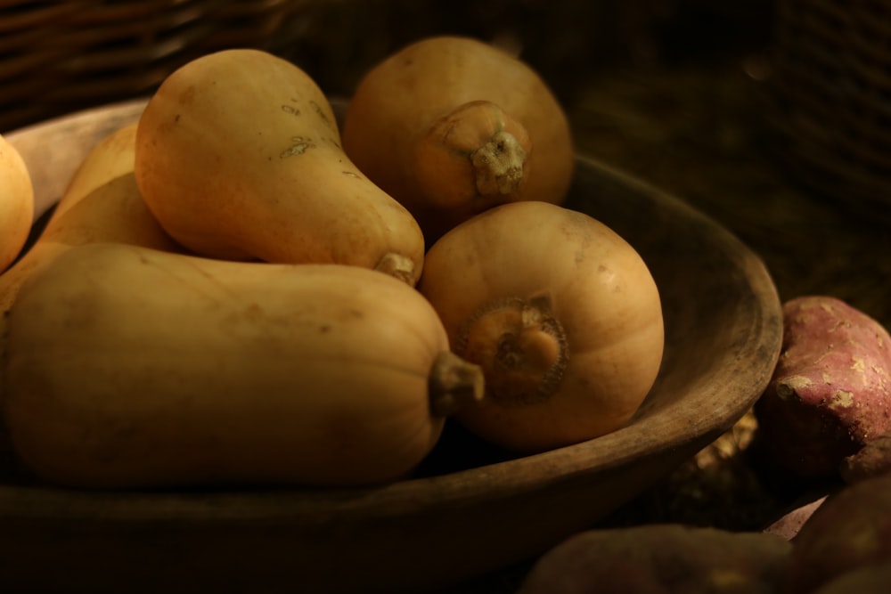 a wooden bowl filled with lots of different types of vegetables