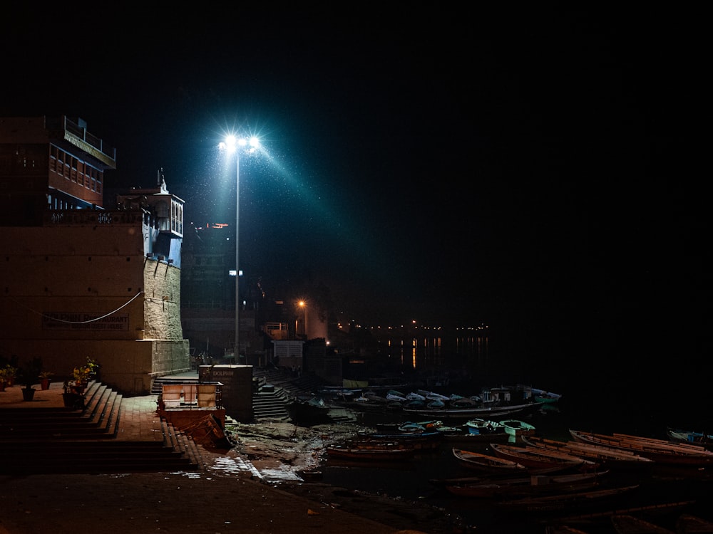 a street light on a dark street next to a body of water