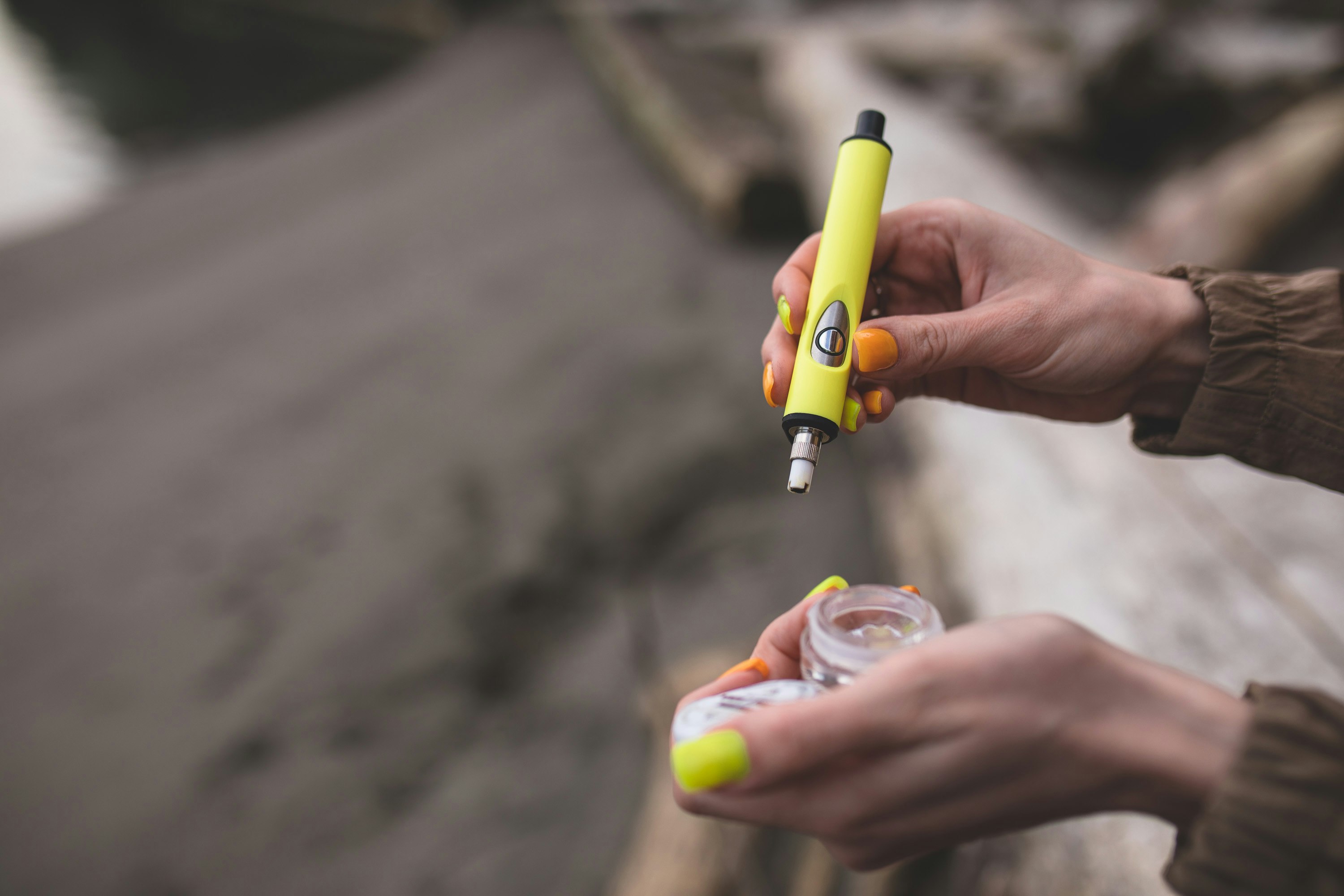 A woman loads a yellow Dip Devices Little Dipper concentrate vaporizer dab straw with cannabis extract. She has bright yellow nails.

See more at https://dipdevices.com/ 