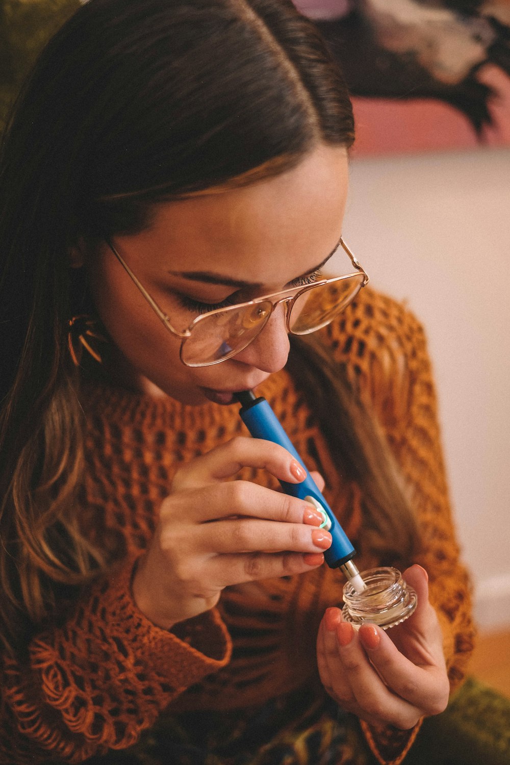 a woman with glasses is brushing her teeth