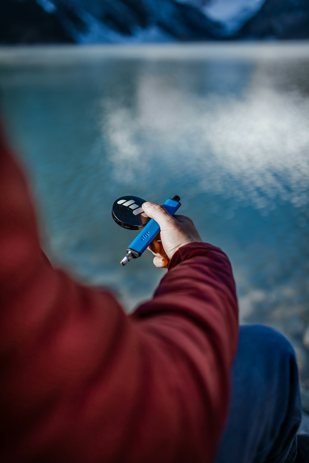 a person holding a remote control in their hand