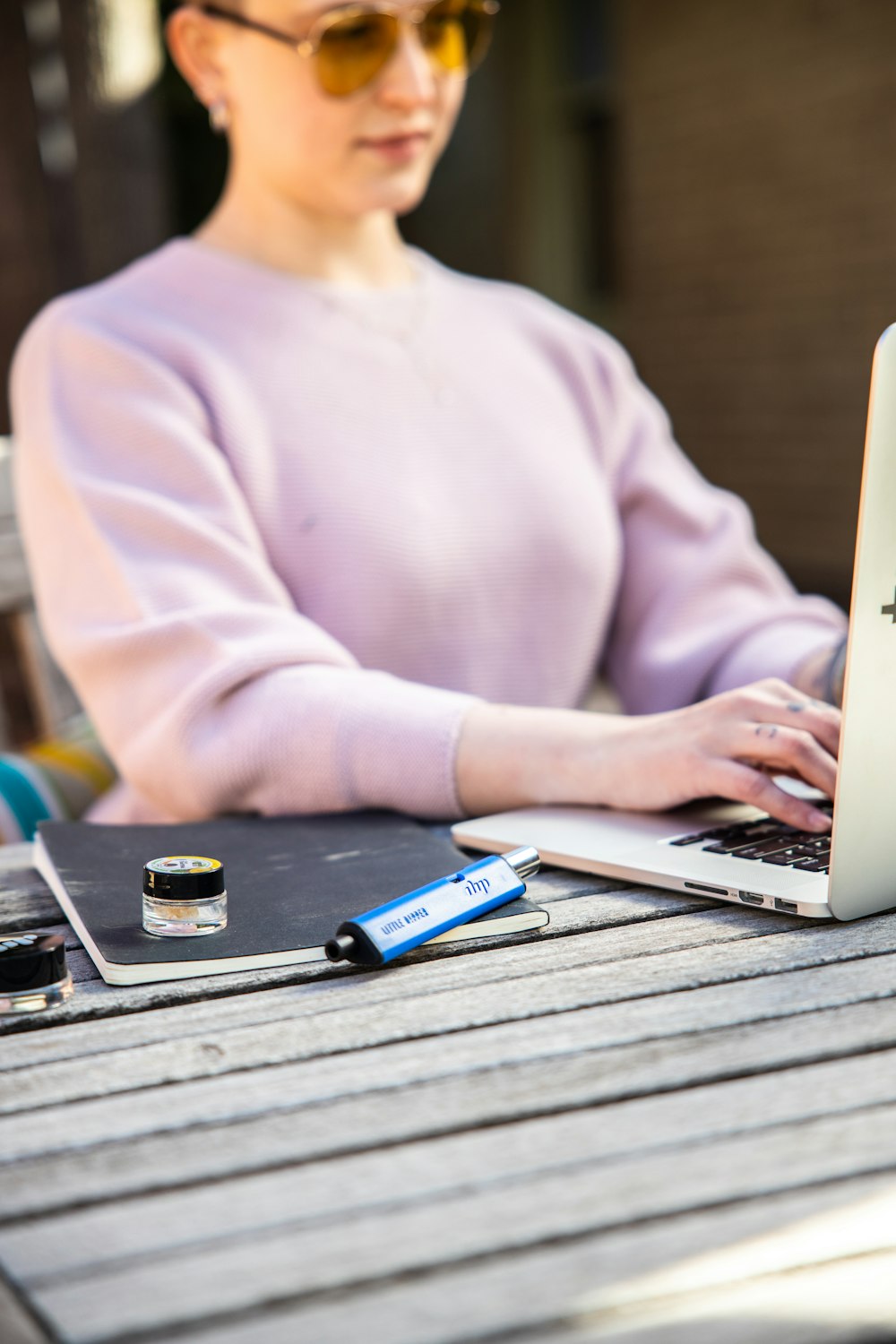 a woman sitting at a table using a laptop computer