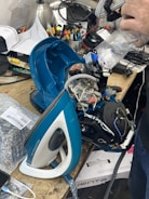 Hoover oven being serviced with tools laid out on a workbench.