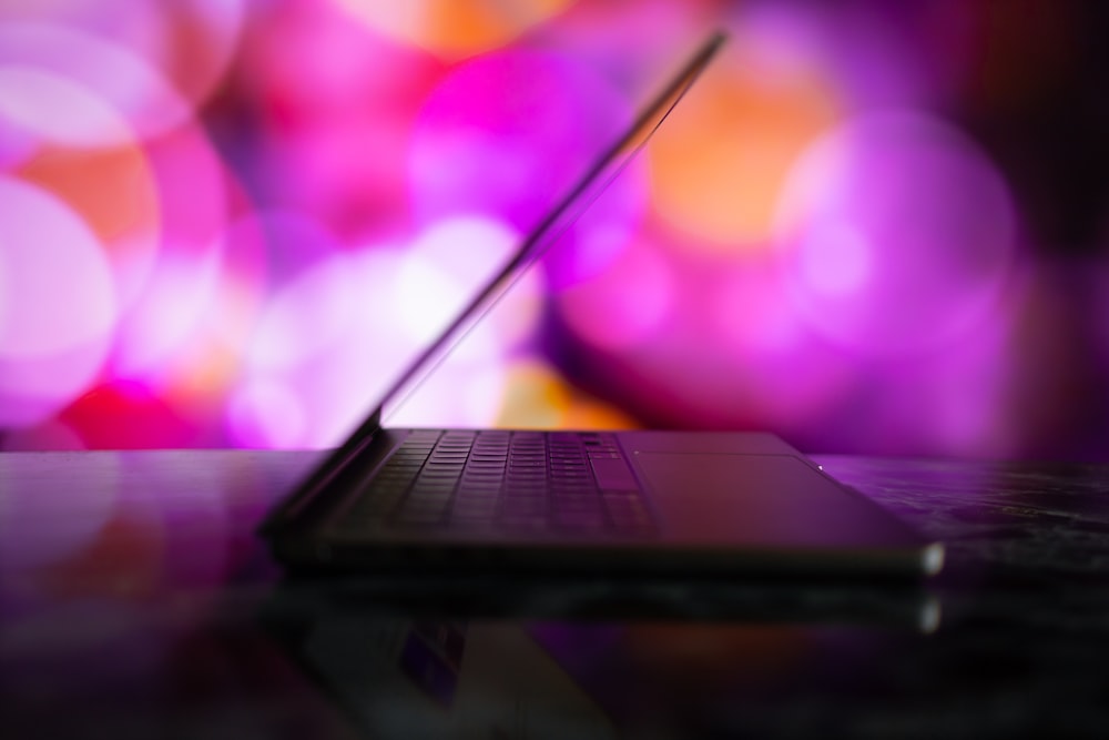 a laptop computer sitting on top of a table