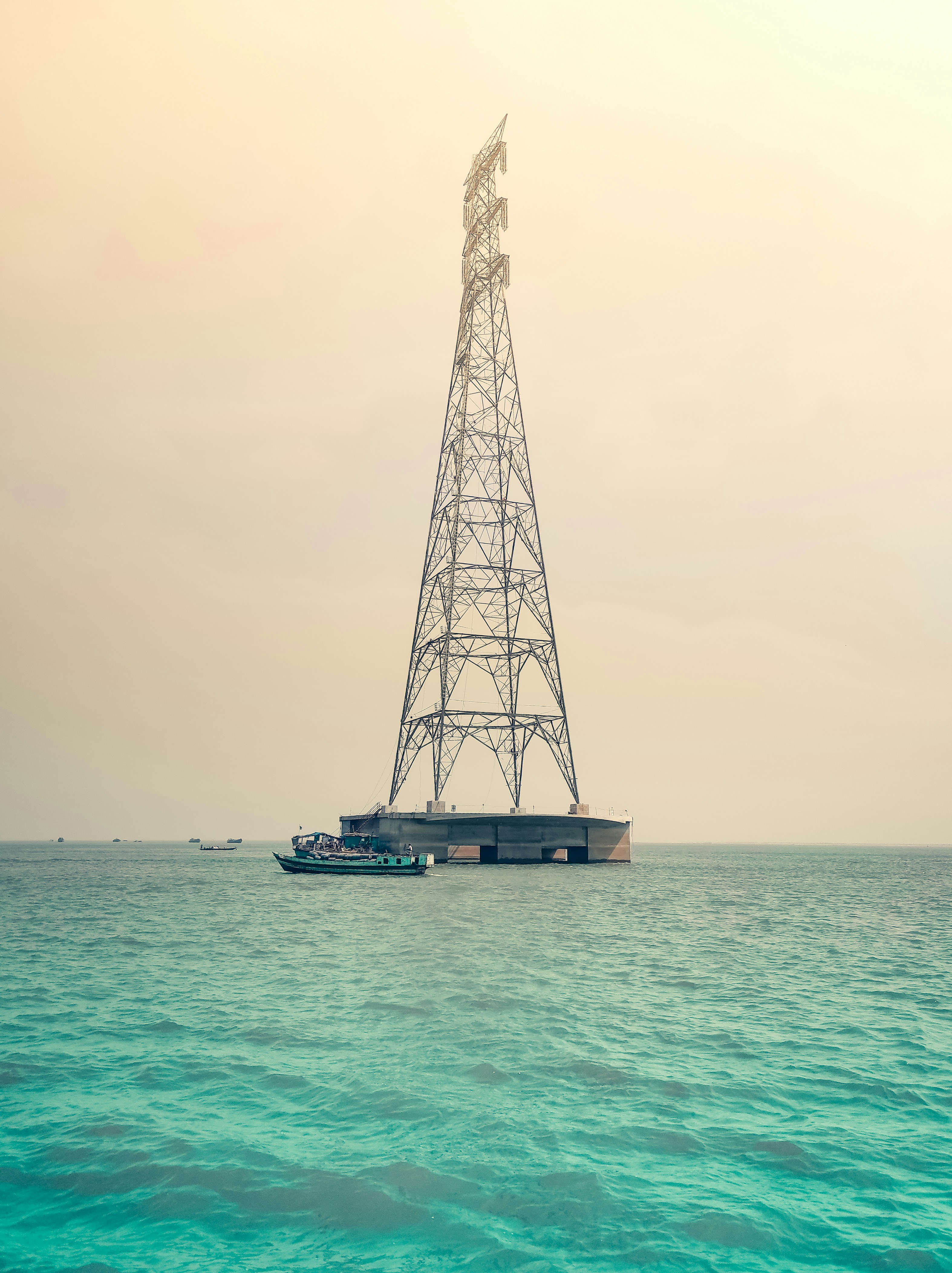 a boat is in the water near a tower