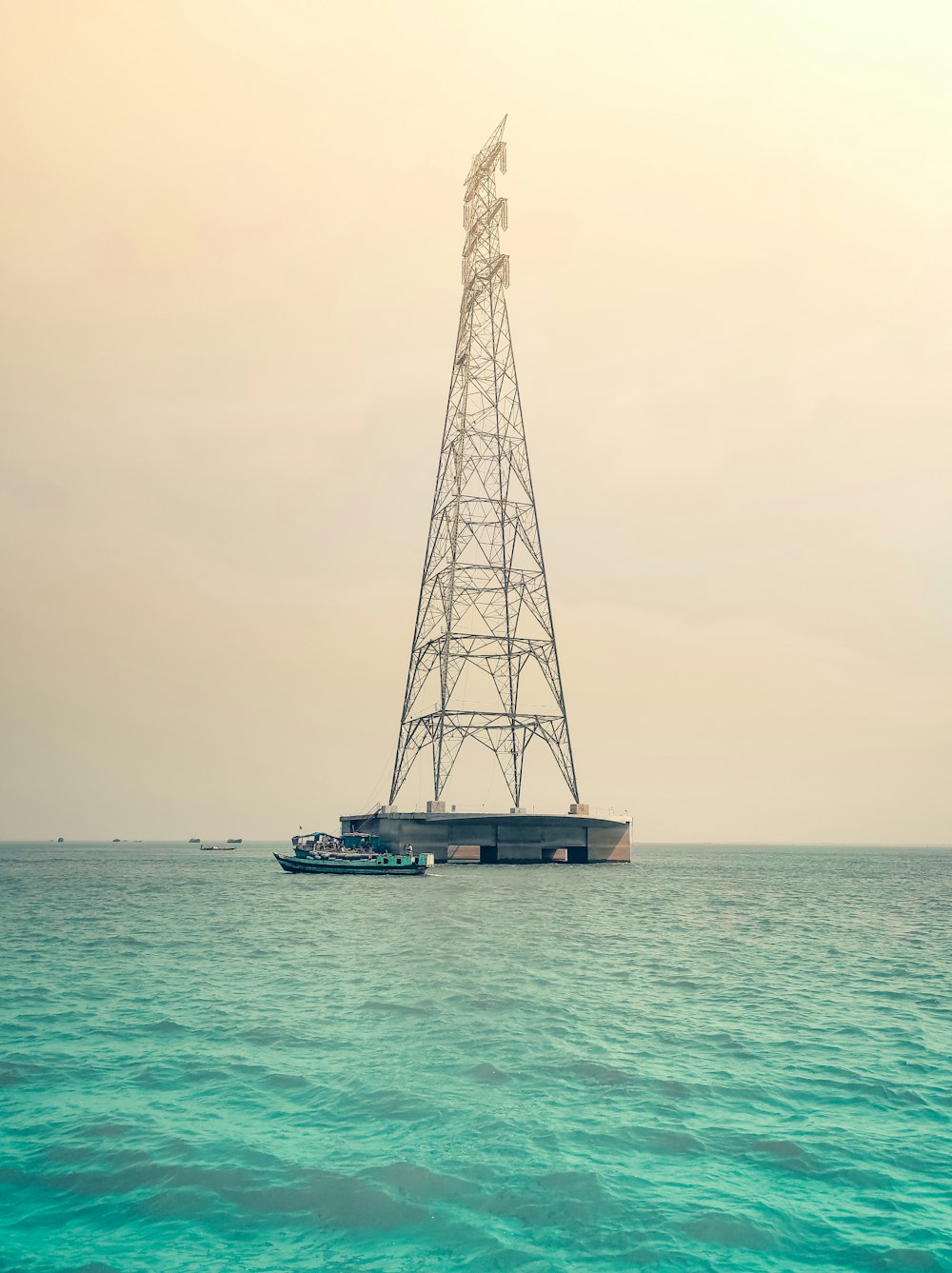 a boat is in the water near a tower