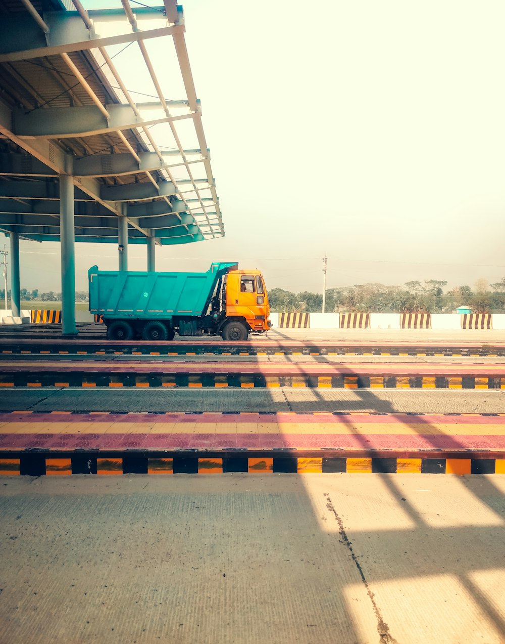 a dump truck parked at a train station