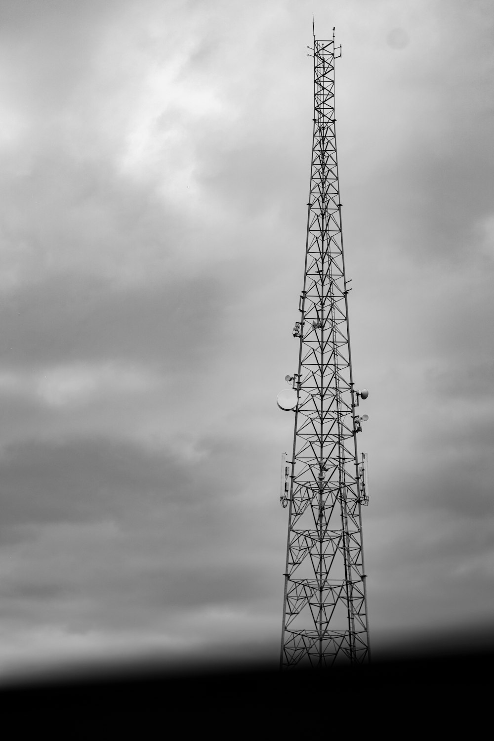 a tall tower sitting under a cloudy sky